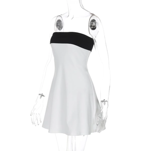 Detail showing the black and white contrast stitching and smooth texture of the bodycon dress