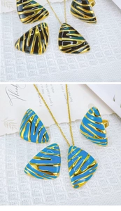 Detail view of triangular earrings and necklaces in black-gold and blue-gold flame patterns