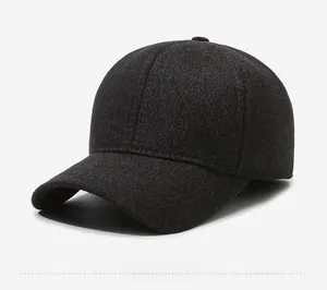 Detail of dark grey winter baseball cap showing thick fabric and metal sports style tag