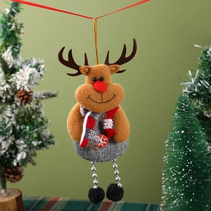 Detailed close-up of a brown plush reindeer ornament with red scarf on a Christmas tree