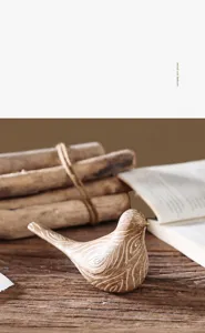 Macro detail of bird sculpture with realistic faux wood grain texture on rustic desk