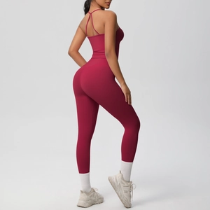 Detail of burgundy yoga set featuring cross-back sports bra and high-waist leggings