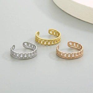 Trois bagues maillons cubains en or, argent et or rose sur un fond minimaliste moderne