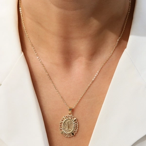 18k gold plated round letter S pendant necklace shown on a white blazer outfit