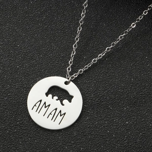 Silver stainless steel mama necklace with bear cutout and pendant on black background
