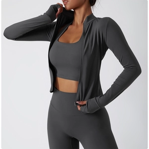 Detail view of dark grey yoga jacket with thumbholes and high-waist fitness leggings