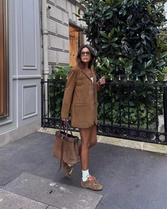Street style shot of brown suede jacket set with matching tote bag and casual sneakers