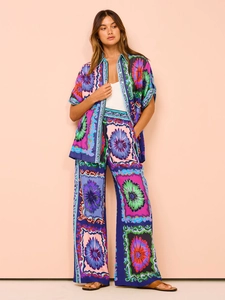 Detailed pattern of colorful floral print on women's short sleeve shirt and wide leg pants