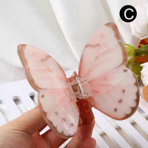 Elegant butterfly hair claw clip with pink and brown gradient wings on a white background
