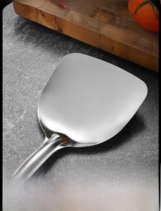 Macro shot of hand-polished stainless steel spatula edge with smooth rounded finish