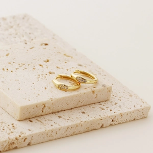 Detailed close-up of gold-plated S925 silver irregular earrings with sparkling crystals