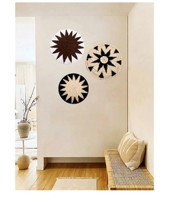 Detailed view of woven seagrass wall plates featuring ethnic geometric sunburst patterns