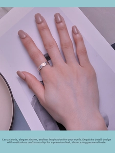 Close-up of S925 sterling silver puzzle hollow ring worn on hand with minimalist aesthetic