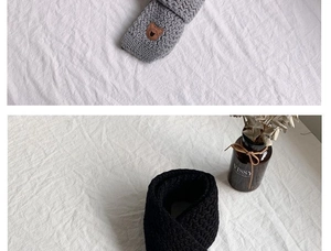 Dettaglio di sciarpe invernali in maglia per bambini con patch orso in grigio e nero