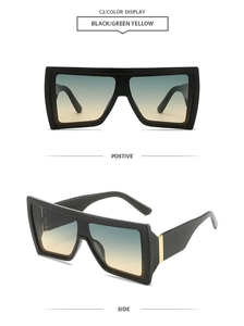 Detail view of oversized square sunglasses with black frame and blue-yellow gradient lenses