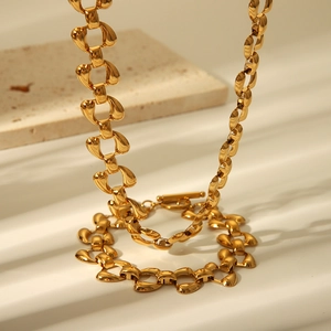 Golden stainless steel necklace and bracelet set with stylized linked chain design