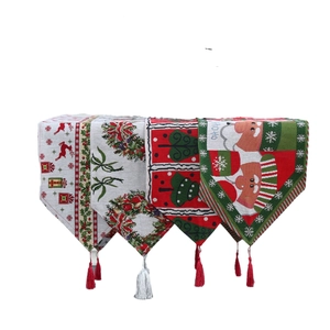Embroidered Christmas table runner with Santa, reindeer, and tassels for holiday dining decor