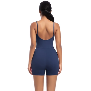 Detail view of navy blue backless yoga jumpsuit with thin straps and elastic fabric