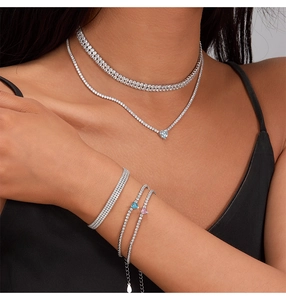 Close-up of S925 sterling silver stamp on a layered tennis heart necklace set
