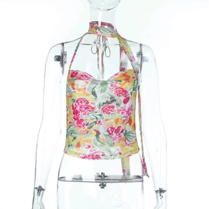 Detail von buntem Neckholder-Top mit Blumenprint und lebhaften rot-gelben Textilmustern