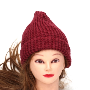 Detailed view of the chunky waffle knit texture on a burgundy winter beanie hat
