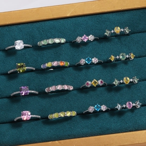 Elegant silver ring collection with colorful zircon and pearls in green velvet display tray