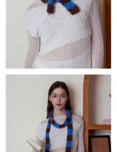 Detailaufnahme des weich gestreiften Strickschals in Blau und Braun mit weißem Top