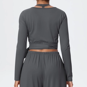 Detail of dark grey yoga set featuring cross-tie back design and soft brushed fabric