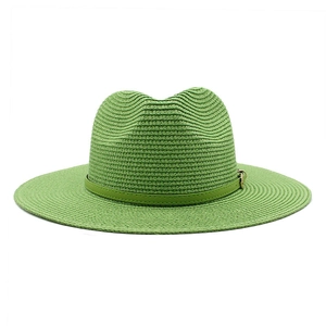 Detail of light green wide brim straw sun hat with decorative leather band and gold buckle