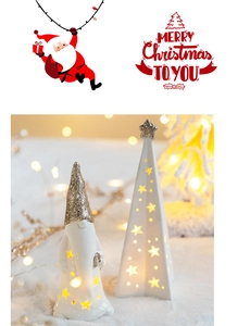 Macro shot of glowing ceramic Christmas gnome and star-shaped tree with gold glitter