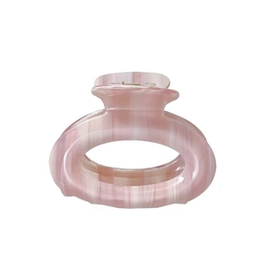 Pink marble texture oval hair claw clip with cream gradient finish for elegant hairstyles