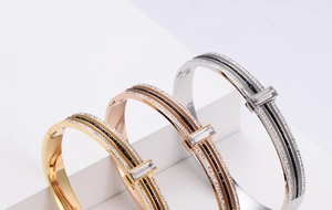 Detailed view of fashion bangles in gold, rose gold and silver with zircon inlays