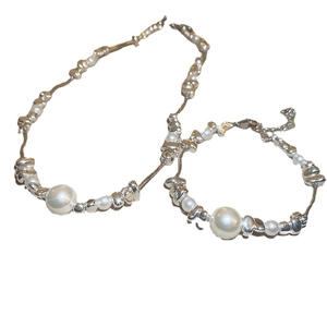 Modern silver irregular bead necklace and bracelet set with an elegant white pearl