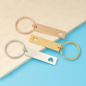 Macro detail of stainless steel keychains in gold, rose gold and silver with hollow heart