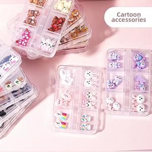 Macro shot of 3D cartoon nail art charms with resin bears and rabbits in a storage box