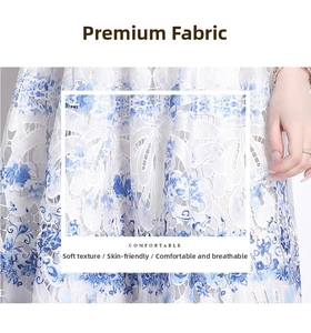 Detail of blue and white hollow lace fabric with intricate floral embroidery and texture
