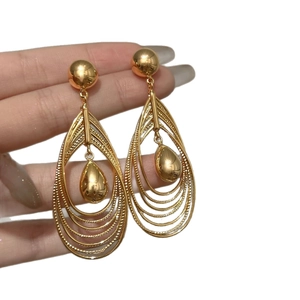 Elegant gold multi-layered water drop earrings on model with high-end polished finish