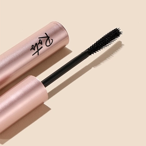 Macro shot of Roto pink metallic mascara tube with brush applicator and black cream