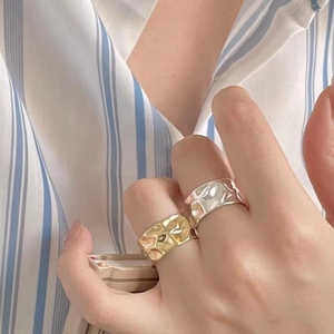 Irregular textured 925 sterling silver ring in gold and silver finish on a finger