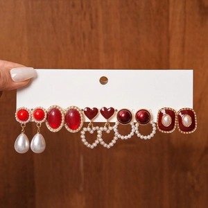 Detailed set of six vintage earrings with red enamel hearts and faux pearls on white card