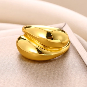 Macro shot of polished gold-plated double-layer water drop ring with mirror finish