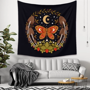 Bohemian black tapestry with orange butterfly, mushrooms, and moon over a modern sofa
