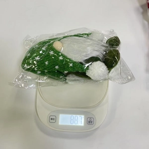 Detailed scale measurement showing the 88.7g weight of the green Christmas gnome plush