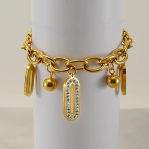 Detailed close-up of a gold chunky link chain bracelet with pavé diamond oval charms