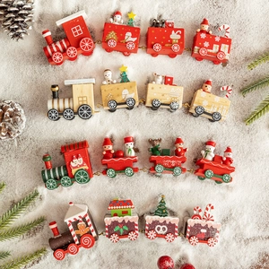 Set of four wooden Christmas train ornaments with festive snowy background scenery