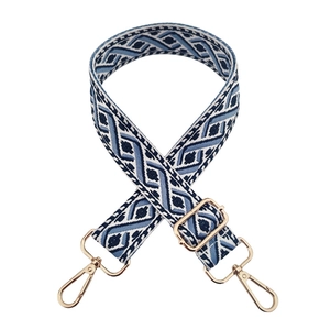 Detail of blue geometric jacquard guitar strap with golden swivel metal hooks