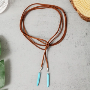 Detail of bohemian long cord necklace with turquoise stone pendants and silver clasps