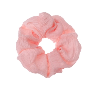 Detailed close-up of a pink pleated fabric scrunchie on a clean white background