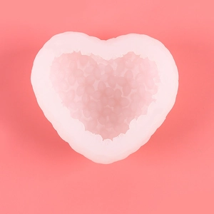 Top view of a white heart-shaped silicone mold with detailed floral petal texture