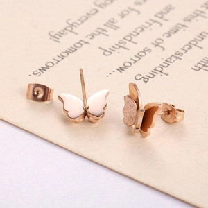Macro shot of 3D rose gold butterfly stud earrings featuring matte and polished finishes